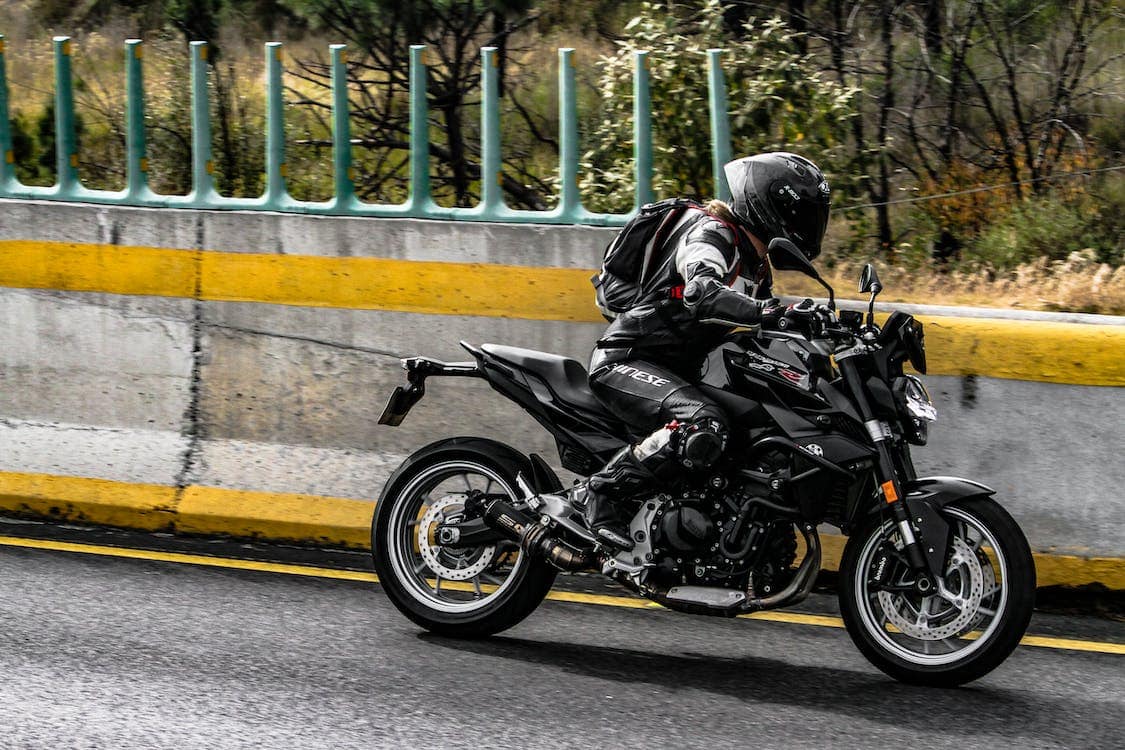 Man Riding a Motorbike on a Road