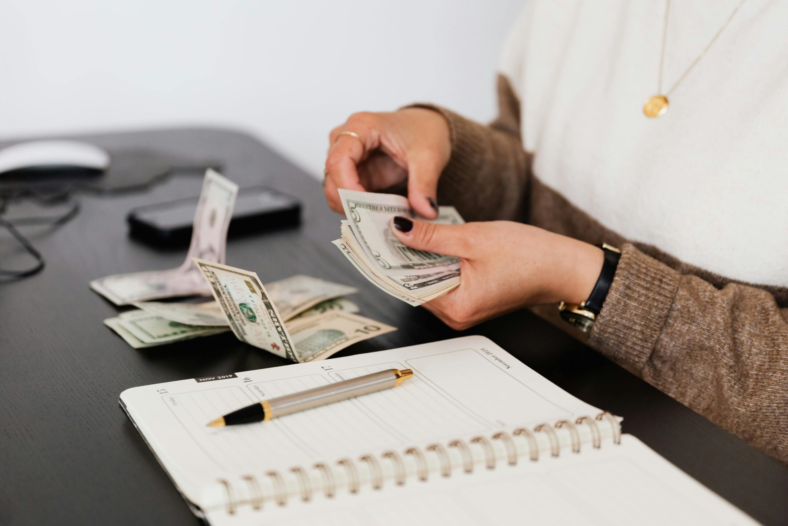 An individual setting money aside for bills.