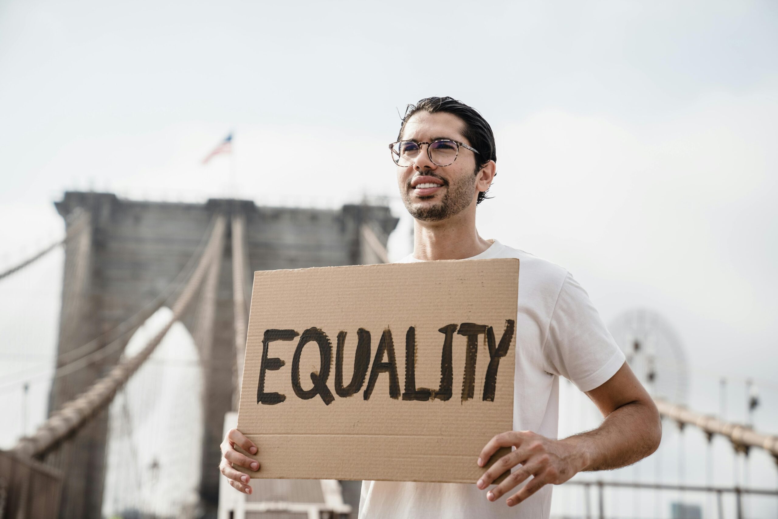 Individual holding up a sign that says Equality.