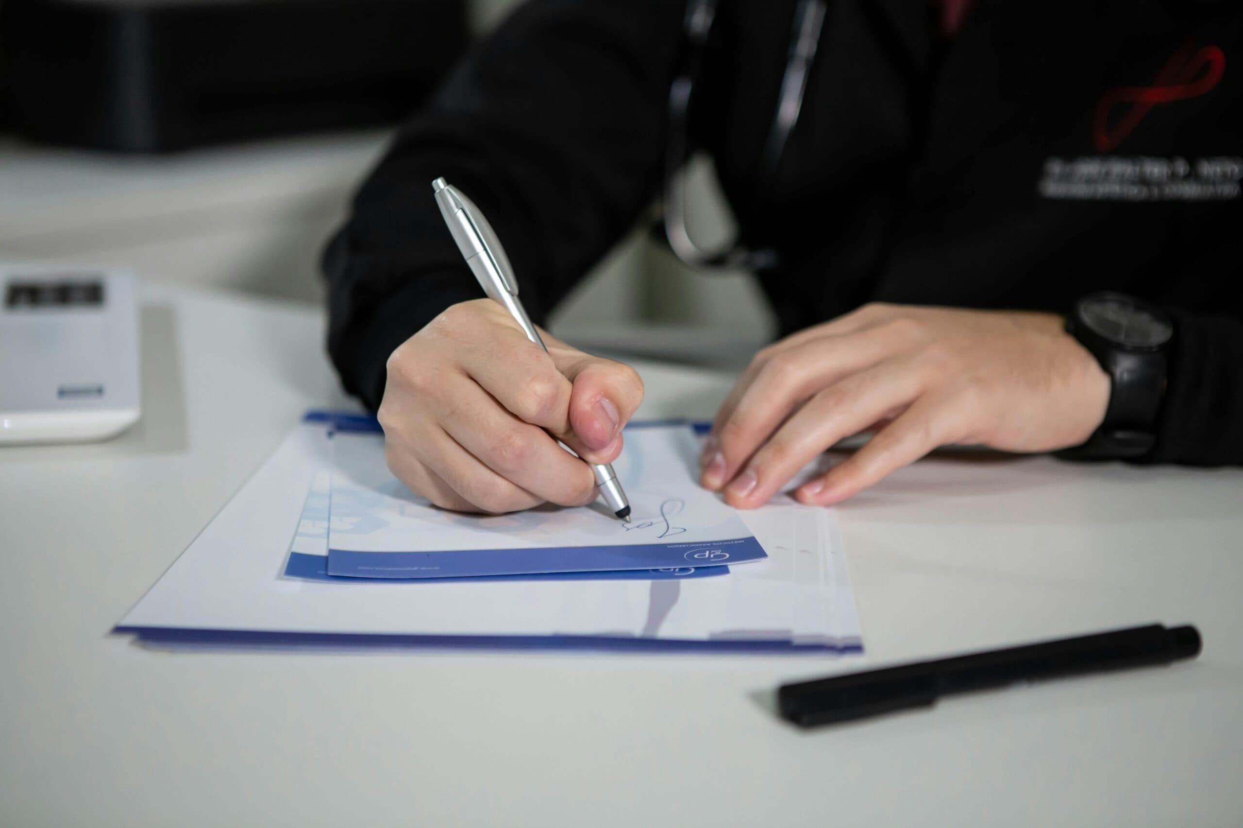 A doctor signing a note.